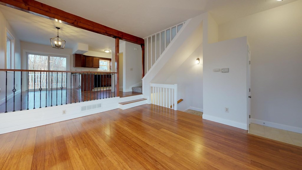 A room with wooden floors and a staircase.