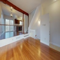 A room with wooden floors and white walls.