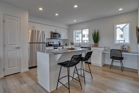 a kitchen with an island and two bar stools