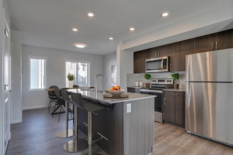 a kitchen with a center island and stainless steel appliances