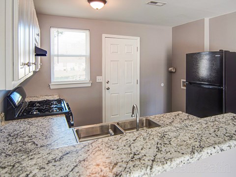 a kitchen with granite counter tops and a sink