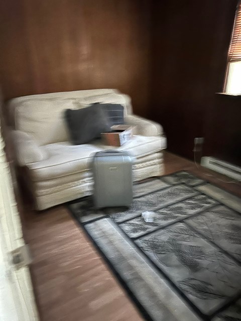 a living room with a couch and a suitcase
