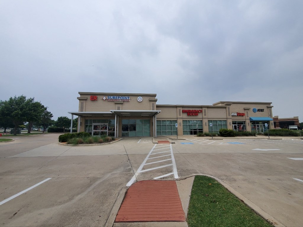 an empty parking lot in front of a shopping center