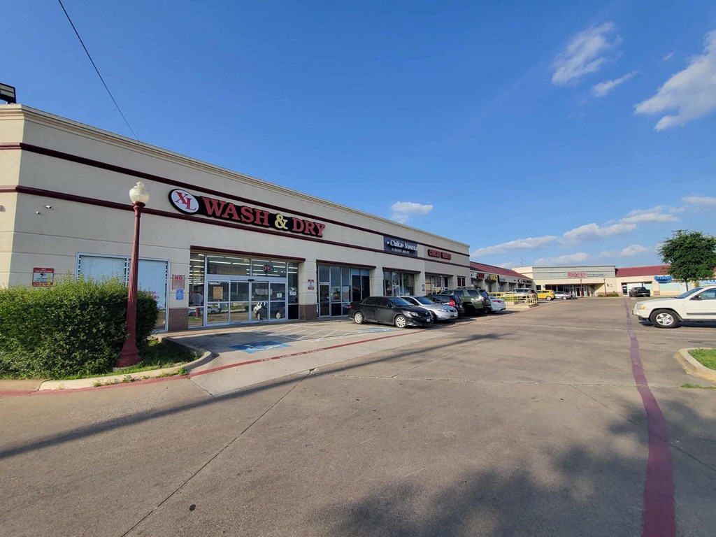 a wash  dry store with cars parked in front of it