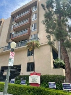 a tall building with a tree in front of it