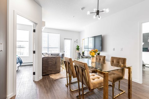 an open living room and dining room with a table and chairs