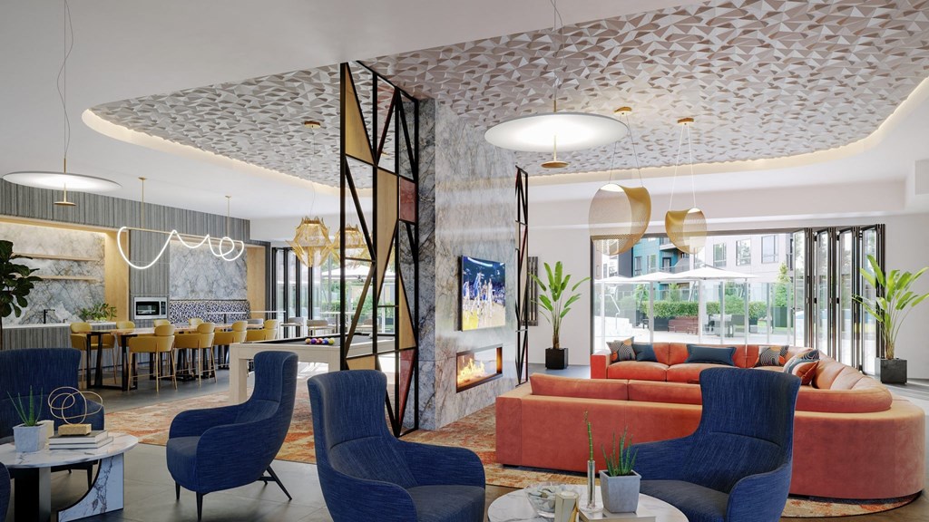 a lobby with blue chairs and a orange couch and a fireplace