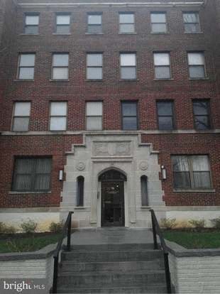 a large brick building with stairs in front of it