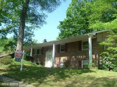 a brick house with a tree in front of it