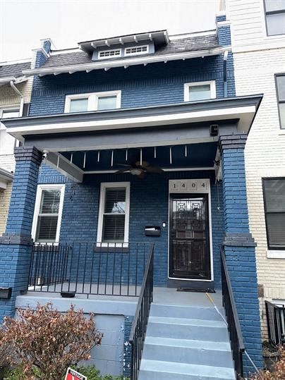 a blue house with a black door and stairs