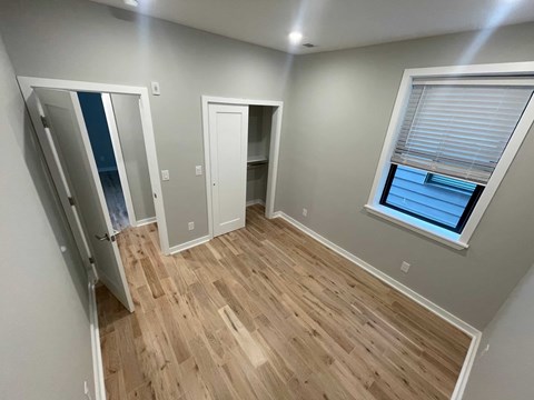 a room with a hard wood floor and a window