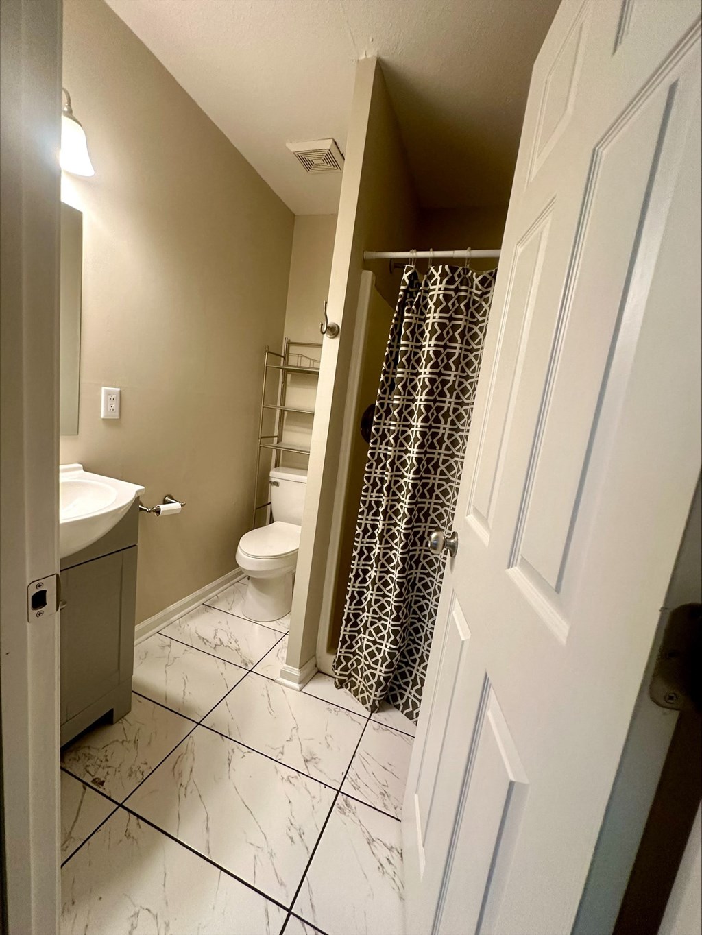 a small bathroom with a shower and a toilet