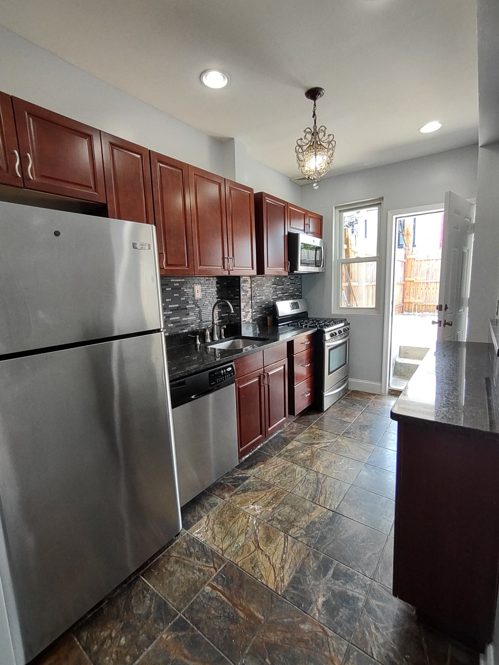 a kitchen with stainless steel appliances and wooden cabinets