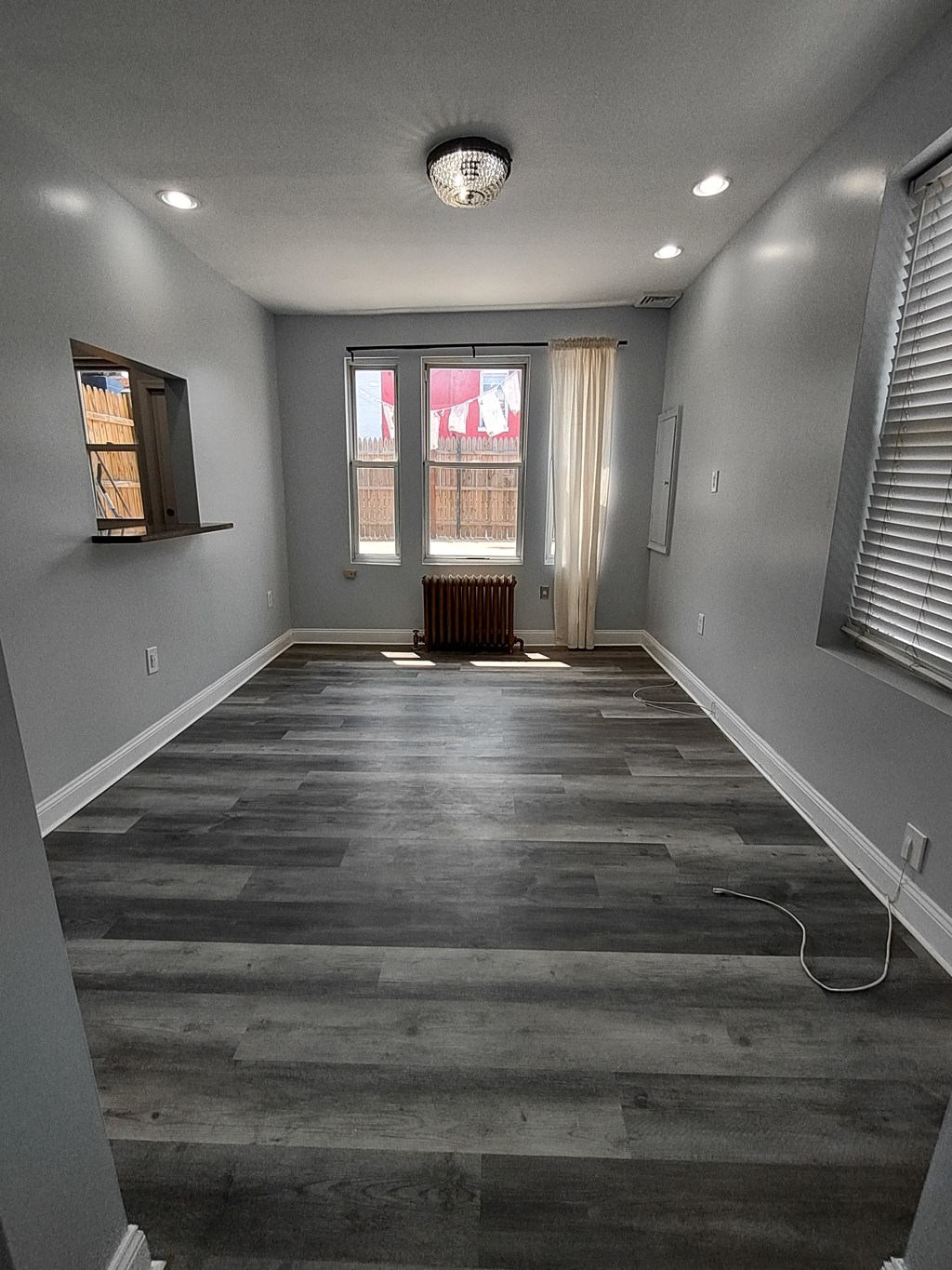 a living room with gray walls and a wooden floor