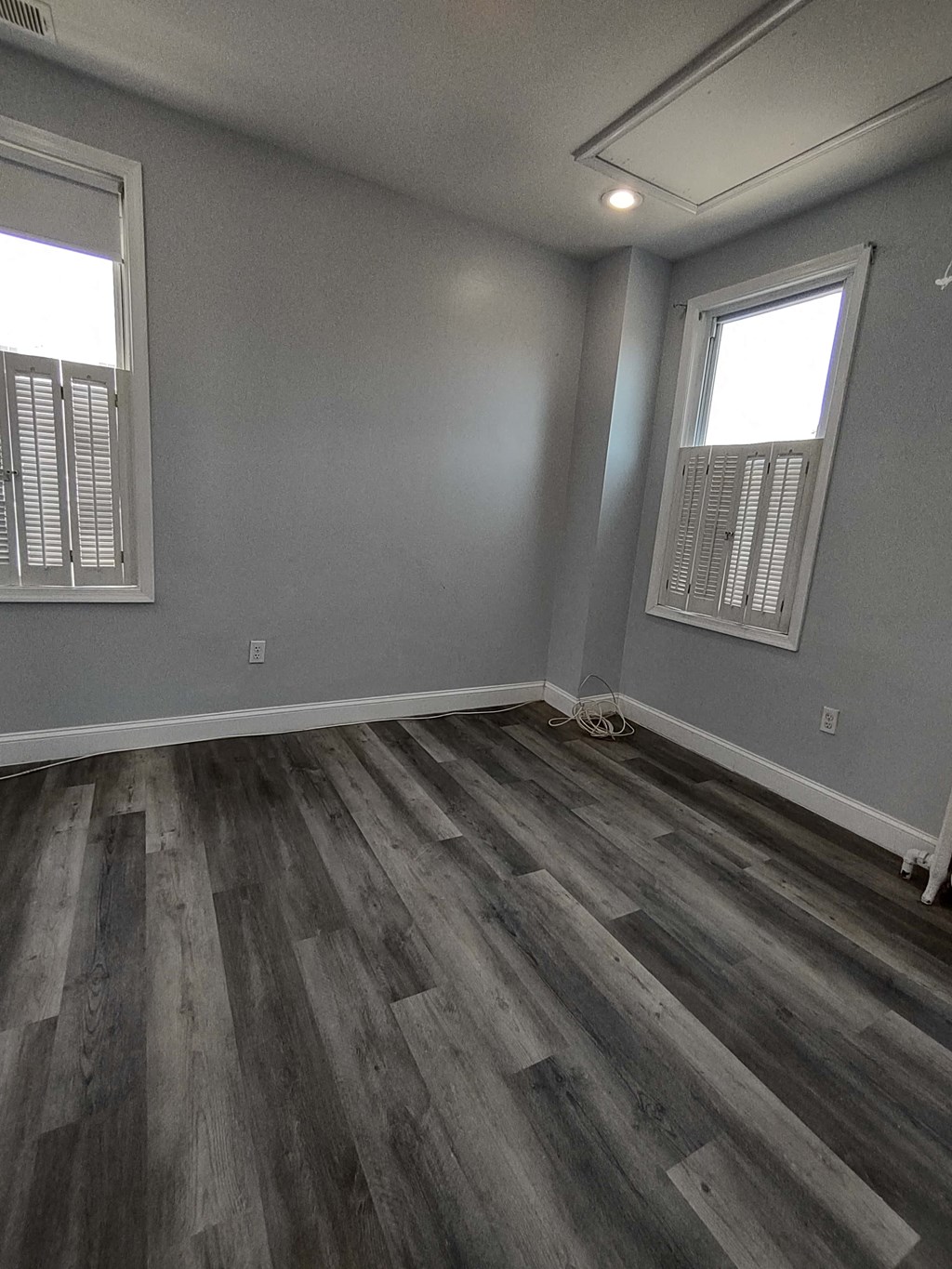 a living room with gray walls and wooden floors