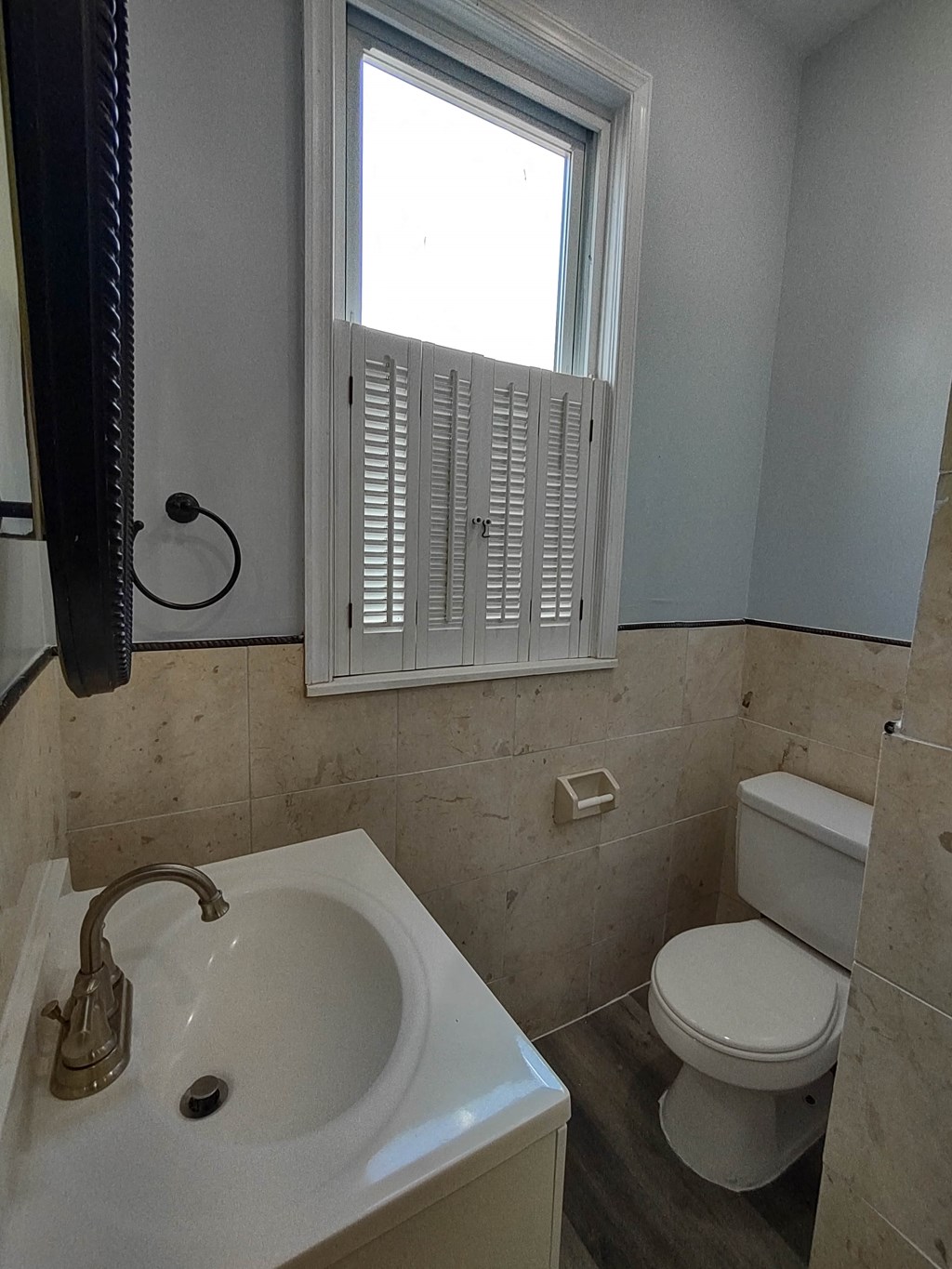 a bathroom with a sink and a toilet and a window