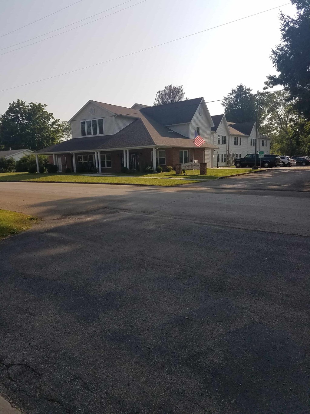 a house with a flag on the corner of a street