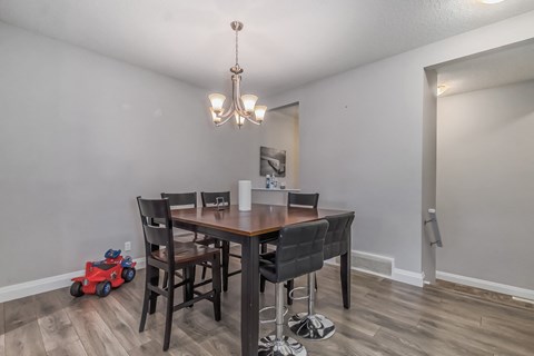 a dining room with a table and chairs and a chandelier