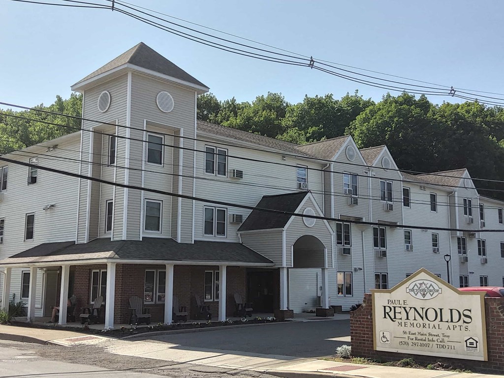 a large white building with a sign in front of it
