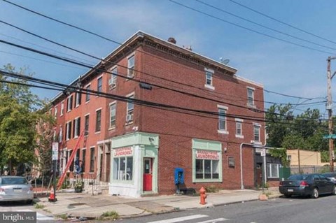 a red brick building on the corner of a street