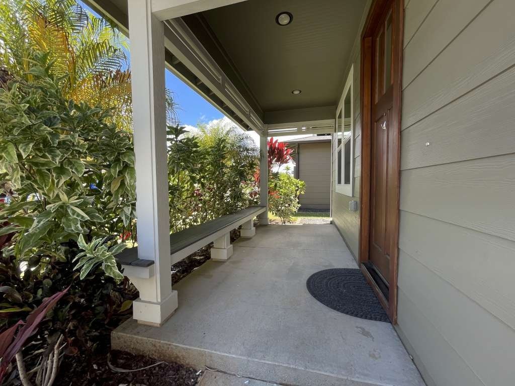 a covered walkway leading to a house