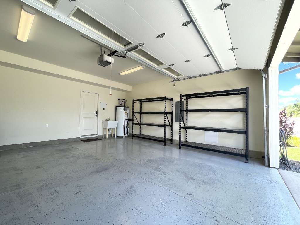 the inside of a garage with a large room with shelving and a door