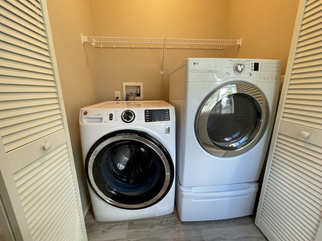 a washing machine and a dryer in a laundry room