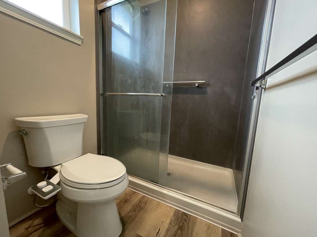 a bathroom with a toilet and a shower