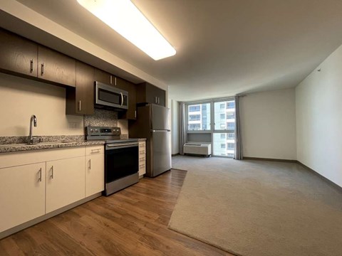 A kitchen with white cabinets and a microwave above the stove.
