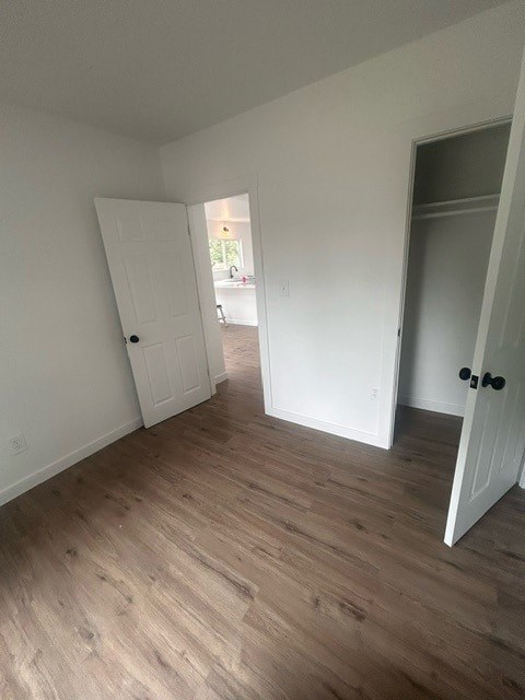 A room with a white door and a black handle.