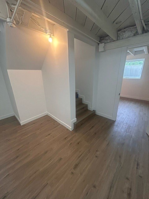 A room with wooden floors and white walls.