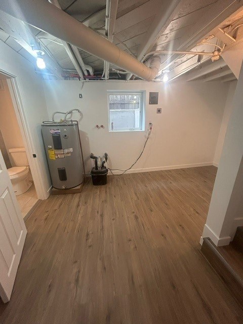 A room with a wood floor and a furnace.