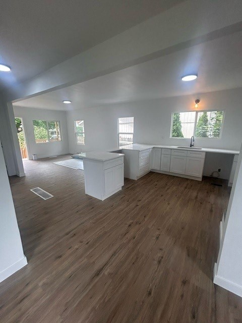 A room with wooden flooring and white walls.