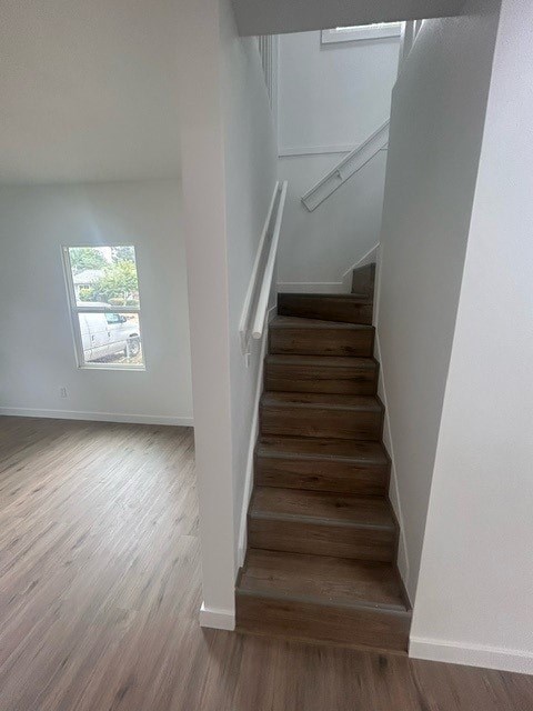 A staircase with wooden steps and a white railing.