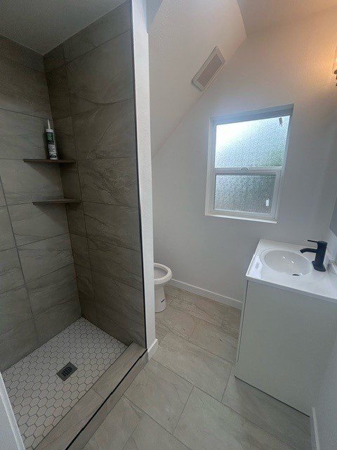 A bathroom with a walk in shower and a window.