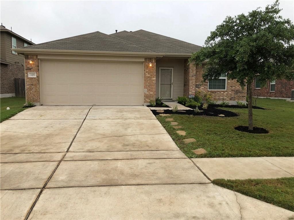 a house with a driveway and a garage door