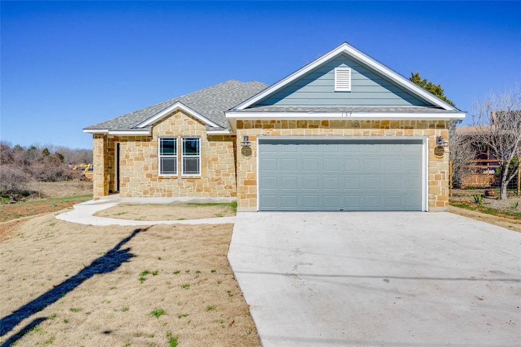 A house with a garage door and a driveway.