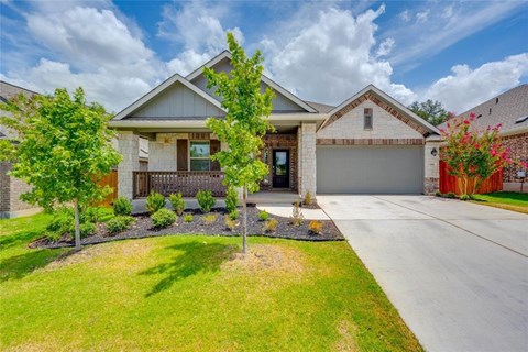 A house with a brown roof and a white garage door.