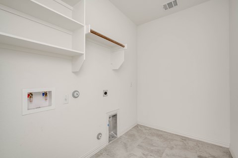 A white room with a small door and a picture on the wall.