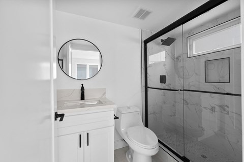 a bathroom with a sink toilet and a shower