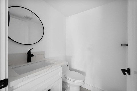 a small bathroom with a white sink and toilet and a mirror