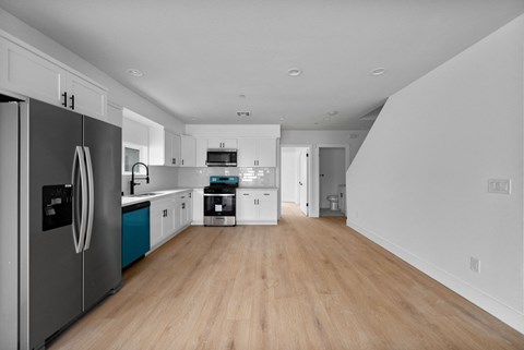 a renovated kitchen with white cabinets and stainless steel appliances