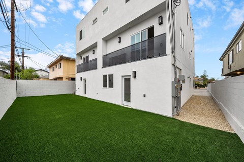 a white building with a green lawn in front of it