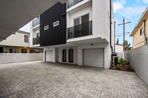 new build house with a garage and a brick driveway