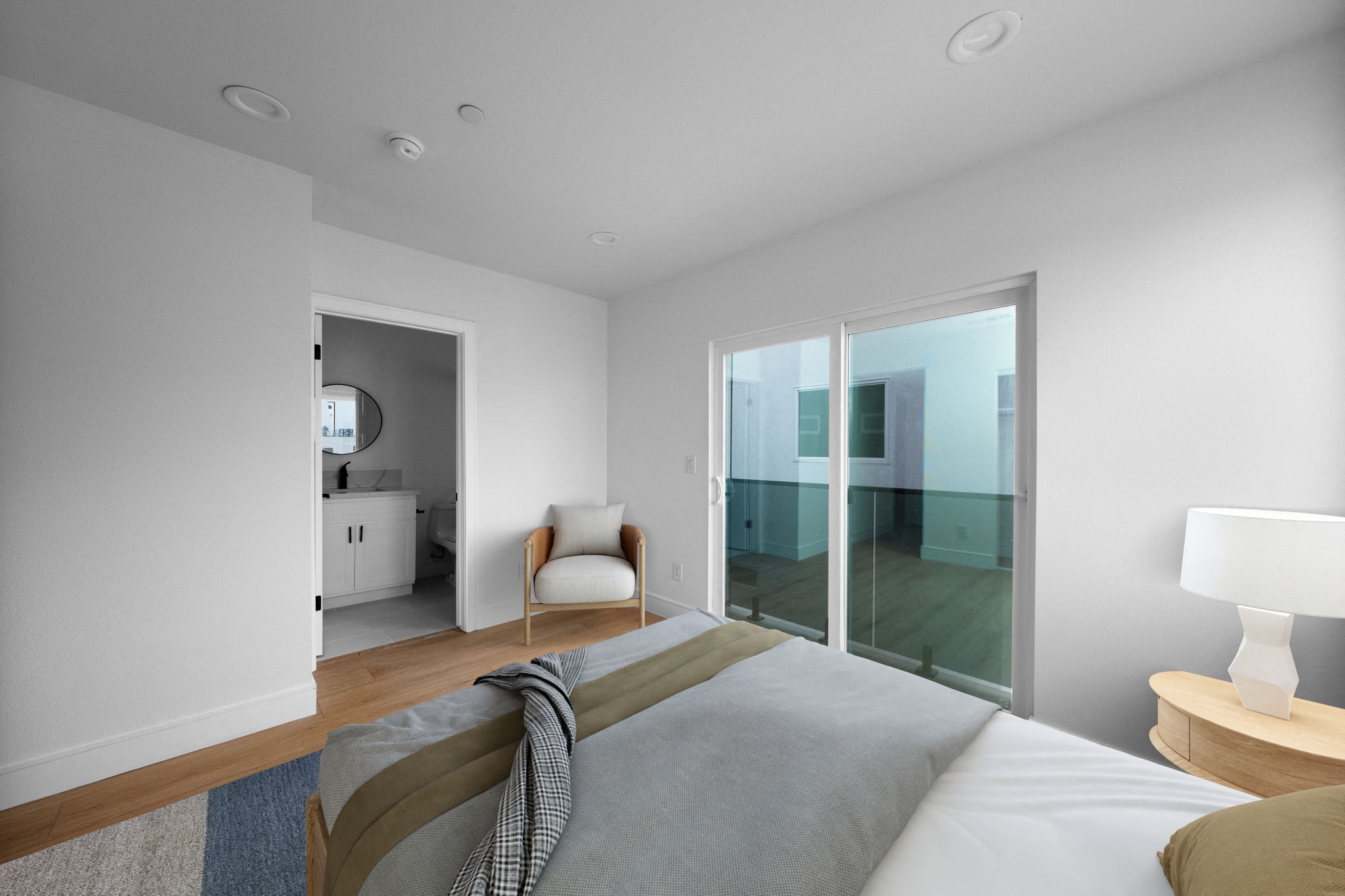 a bedroom with a large bed and a sliding glass door