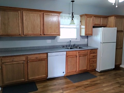 a kitchen with wooden cabinets and a white refrigerator