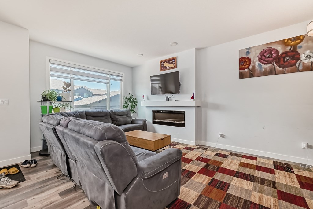 a living room with a couch and a chair and a tv