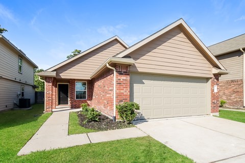 a brick house with a white garage door