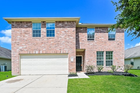 a large brick house with a white garage door