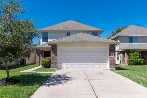 a white garage door in front of a house